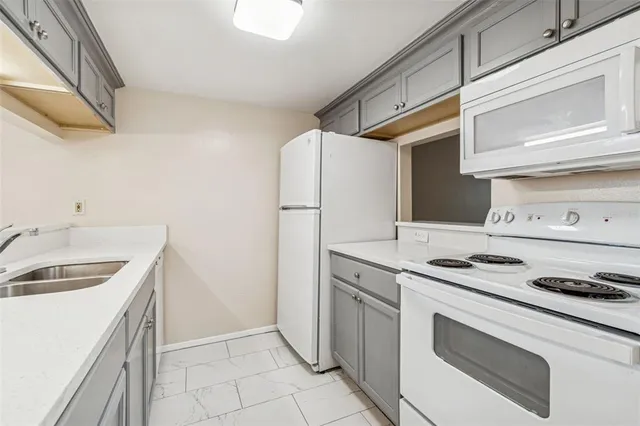 an empty room with wooden floor chandelier fan and closet area