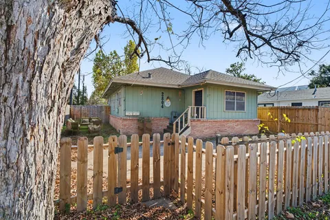 a front view of house with a garden