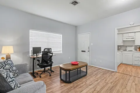 a living room with furniture and a table