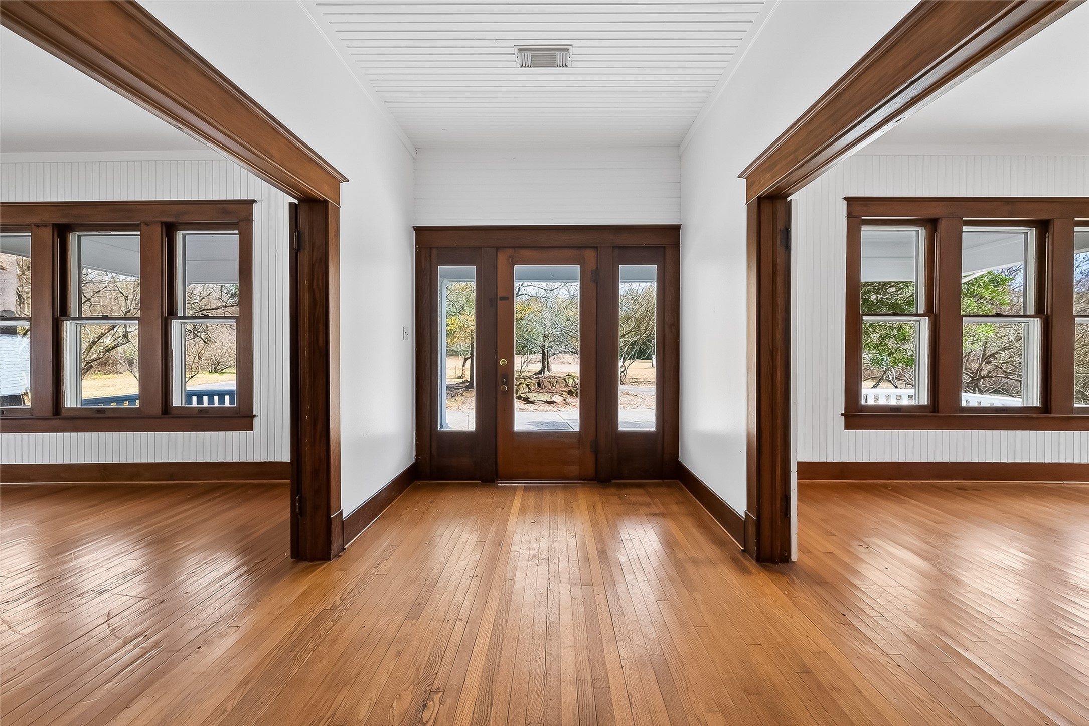 38011 Spur 149 Road Magnolia, TX 77354 - Photo 12 of 50 What a charming entryway that opens into a long, shelved hallway. On the right and left, you'll find a large living room and a comfortable bedroom, making the entrance both inviting and functional.