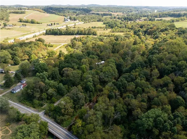 an aerial view of residential houses with outdoor space and mountain view