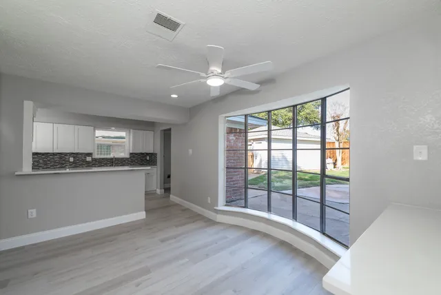 a view of kitchen with granite countertop cabinets and wooden floor