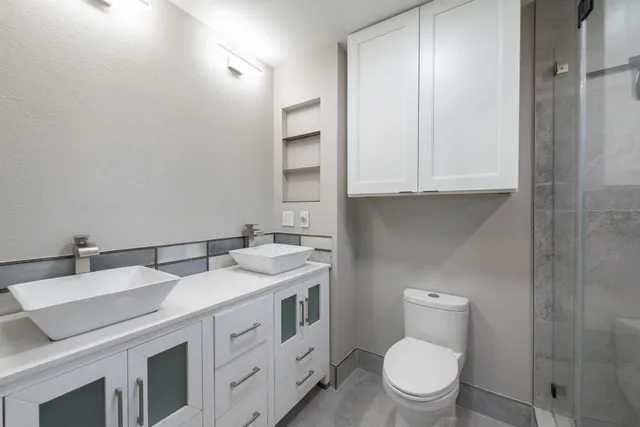 a bathroom with a toilet sink and mirror