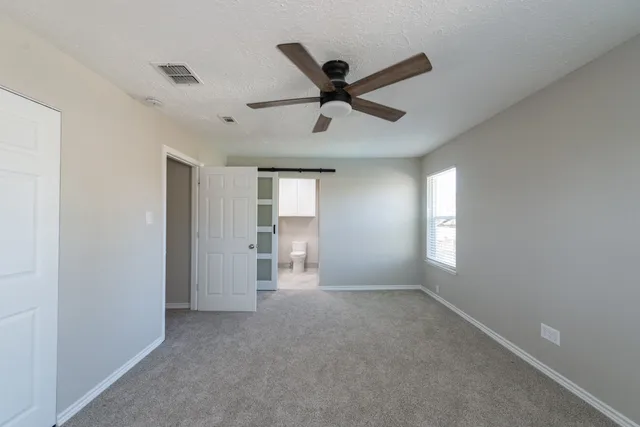 a view of a livingroom with a ceiling fan and window