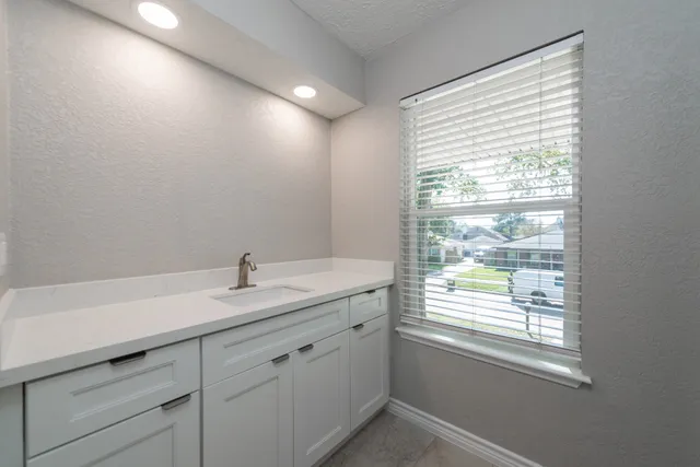 a bathroom with a sink and a window
