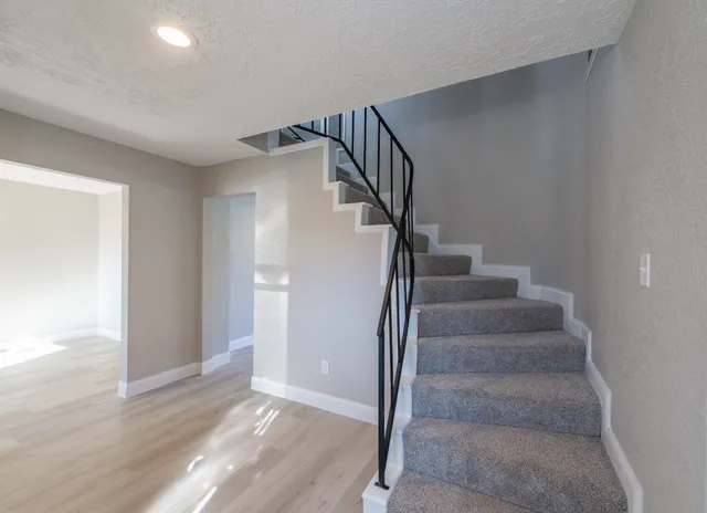 a view of entryway and hall with wooden floor