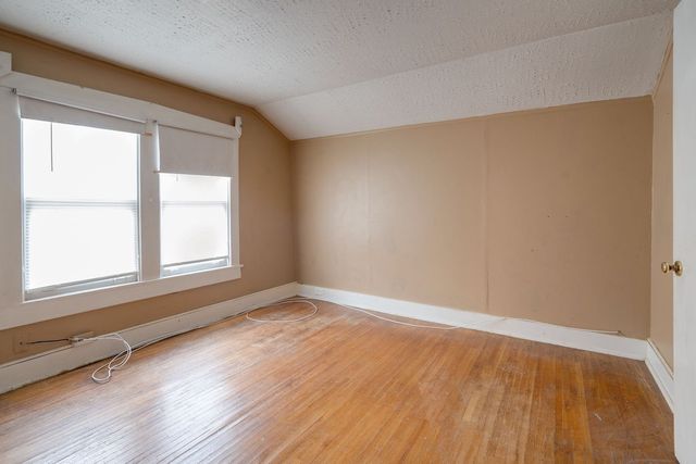 a front view of a house with a wooden deck