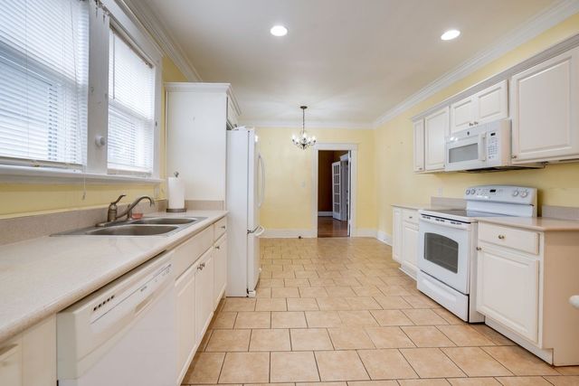 a kitchen with stainless steel appliances granite countertop a sink and cabinets