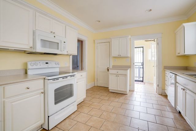 a kitchen with a stove top oven sink and cabinets