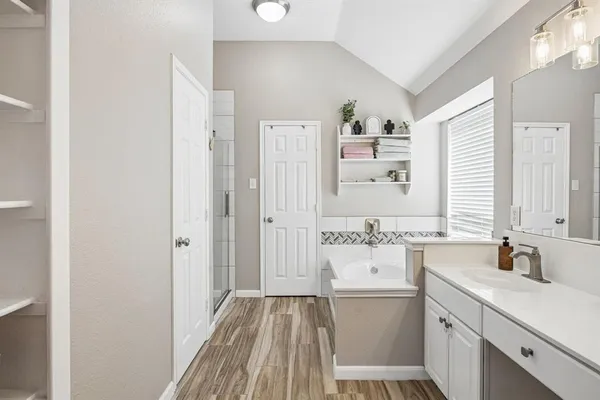 a bathroom with a sink a large mirror and a shower