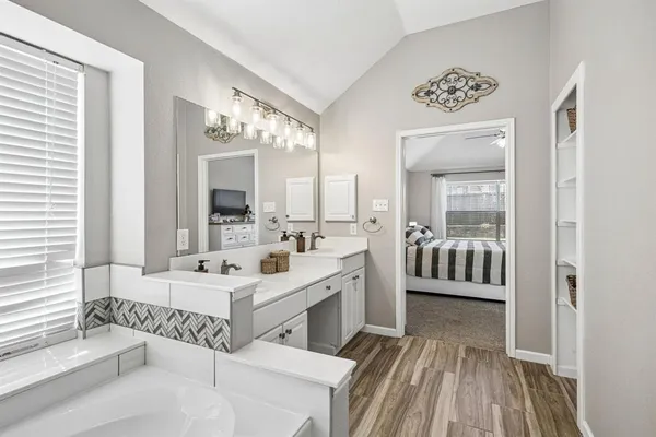 a spacious bathroom with a double vanity sink and a mirror