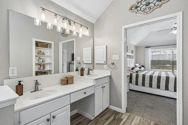 a en suite bathroom with a double vanity sink a mirror and a shower