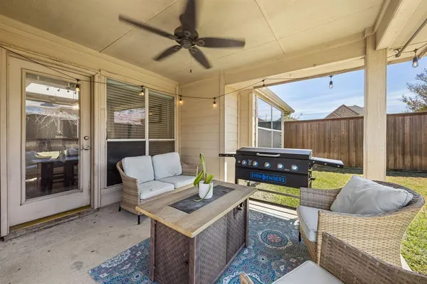 a view of a patio with couches chairs and a fire pit