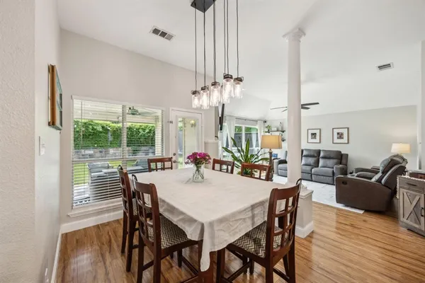 a view of a dining room with furniture window and wooden floor