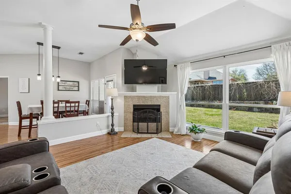 a living room with furniture a fireplace and a flat screen tv