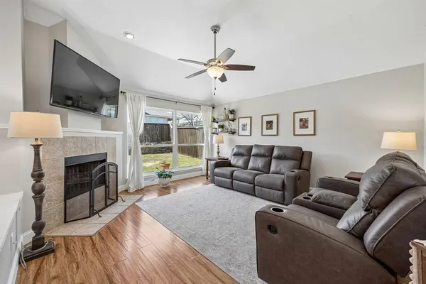 a living room with furniture fireplace and flat screen tv