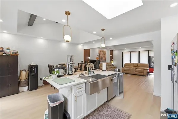 a kitchen that has a lot of cabinets a sink and appliances