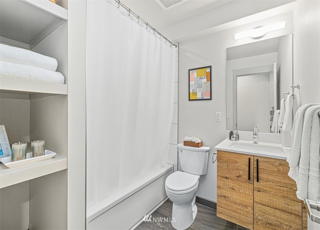 5517 4th Avenue Northwest Seattle, WA 98107 - Photo 11 of 18 a bathroom with a sink a toilet and a mirror
