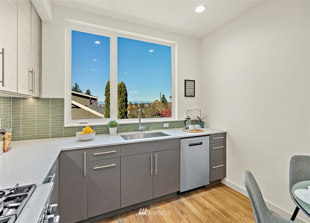 5517 4th Avenue Northwest Seattle, WA 98107 - Photo 5 of 18 a kitchen with a sink and wooden cabinets