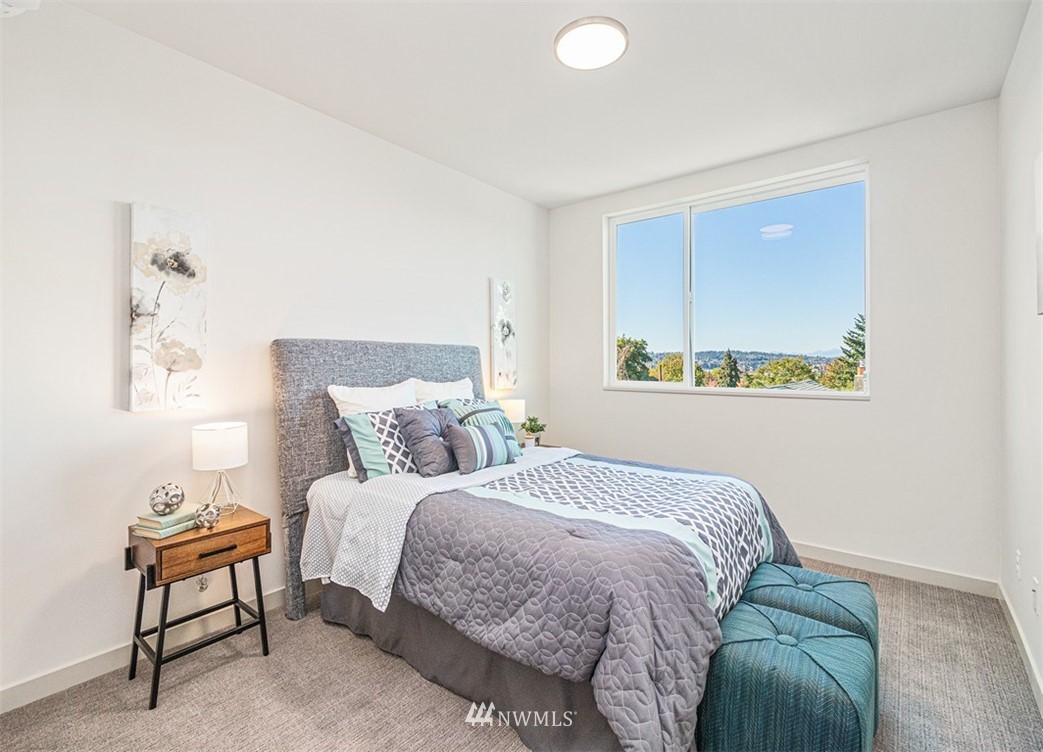 5517 4th Avenue Northwest Seattle, WA 98107 - Photo 7 of 18 a bedroom with a bed and a lamp on dresser