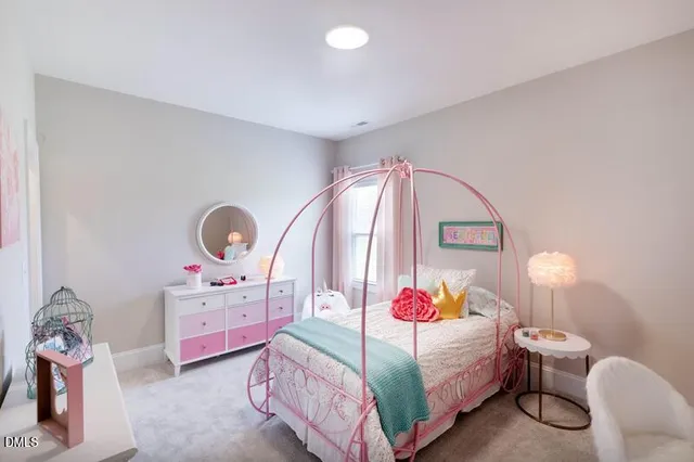 a bedroom with a bed a window and dresser