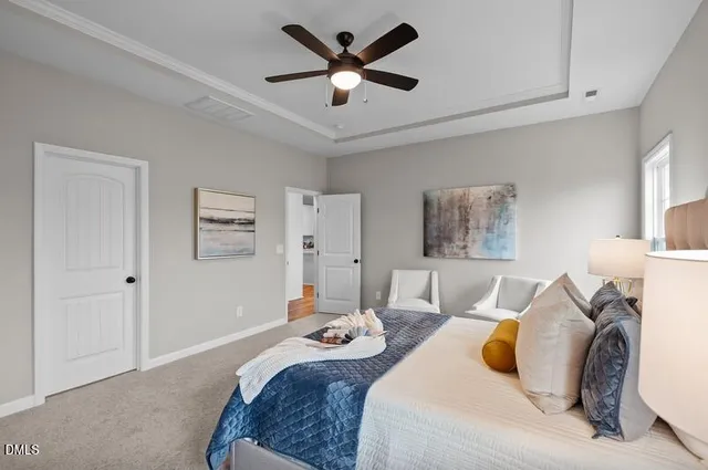 a bedroom with bed and a chandelier