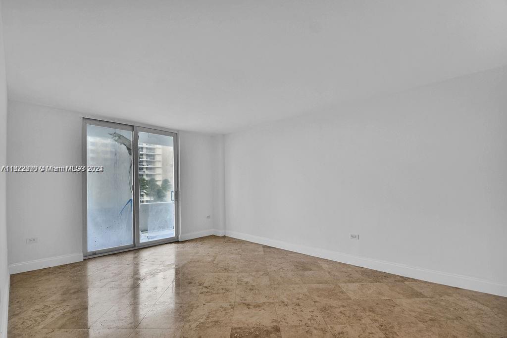 5555 Collins Avenue, Unit 5V Miami Beach, FL 33140 - Photo 3 of 46 an empty room with windows