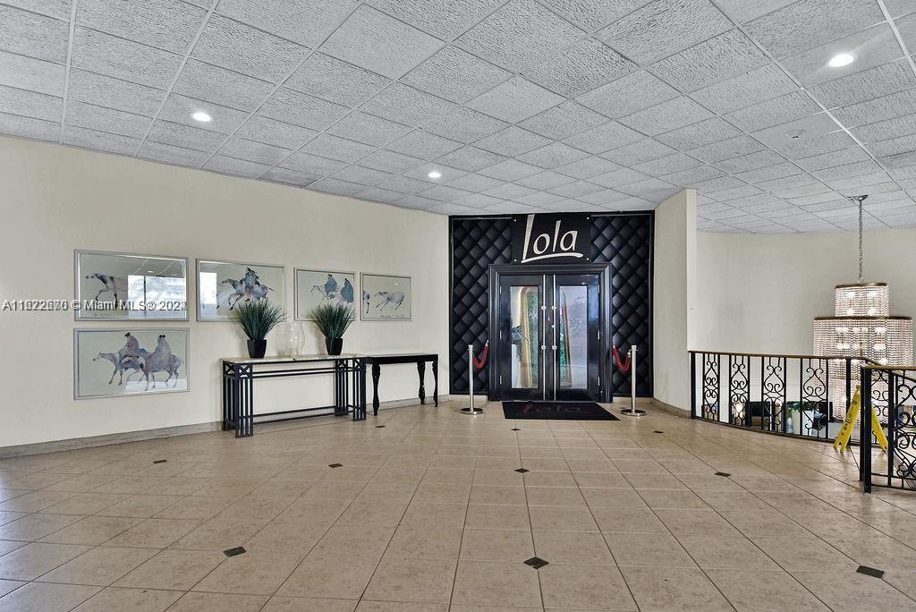 5555 Collins Avenue, Unit 5V Miami Beach, FL 33140 - Photo 32 of 46 a view of a hallway with furniture