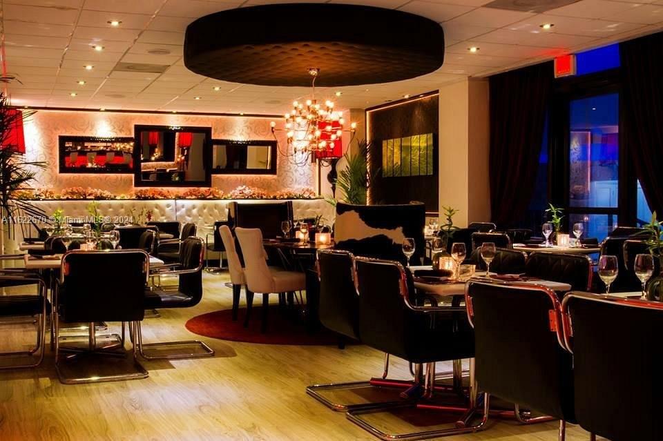 5555 Collins Avenue, Unit 5V Miami Beach, FL 33140 - Photo 34 of 46 a room with lots of chairs and mirrors