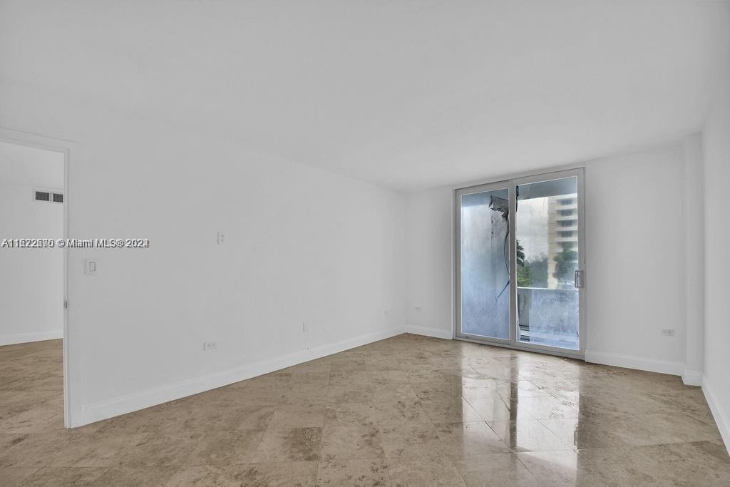 5555 Collins Avenue, Unit 5V Miami Beach, FL 33140 - Photo 4 of 46 an empty room with an entrance to other room