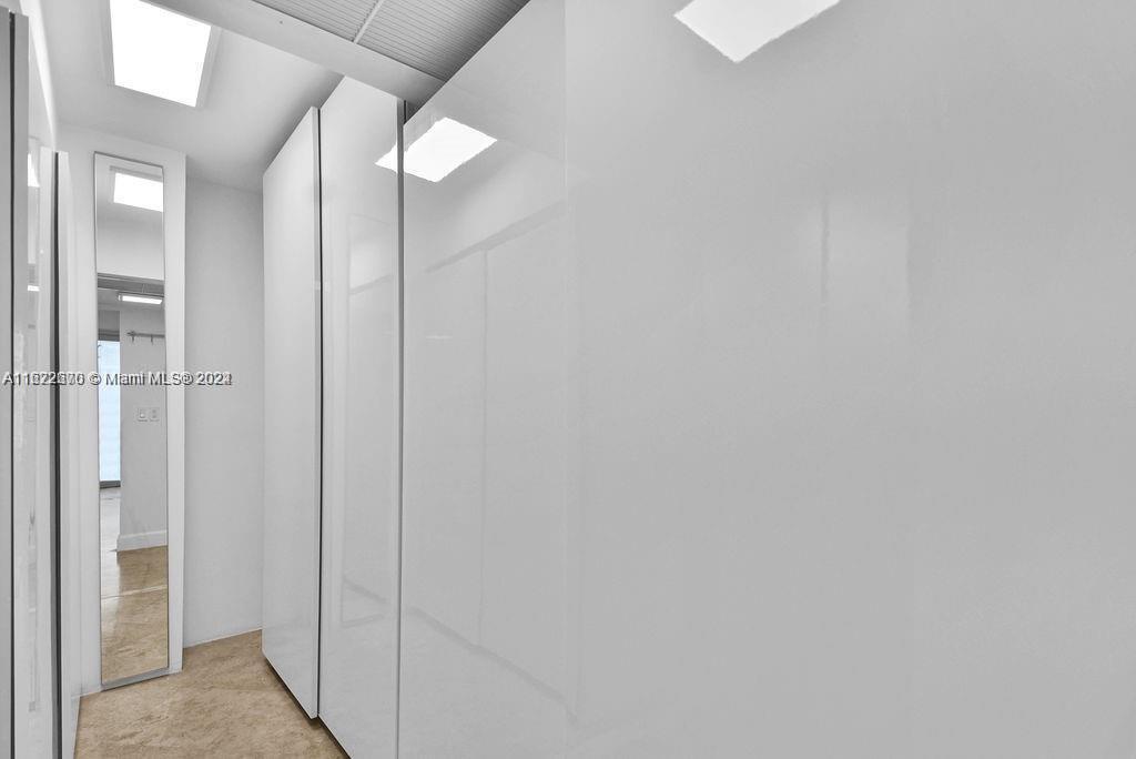 5555 Collins Avenue, Unit 5V Miami Beach, FL 33140 - Photo 7 of 46 a bathroom with a mirror and a shower
