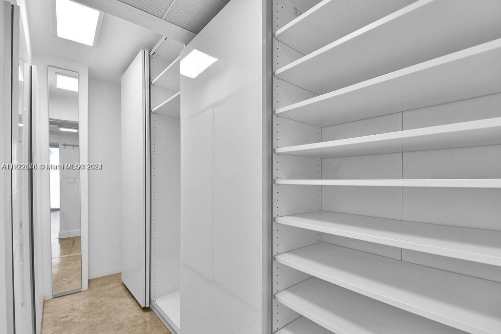5555 Collins Avenue, Unit 5V Miami Beach, FL 33140 - Photo 8 of 46 a view of walk in closet with empty racks