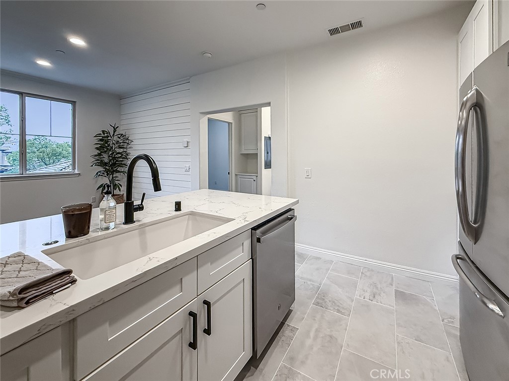 6834 Simmons Way Moorpark, CA 93021 - Photo 14 of 40 a kitchen with a sink and a refrigerator
