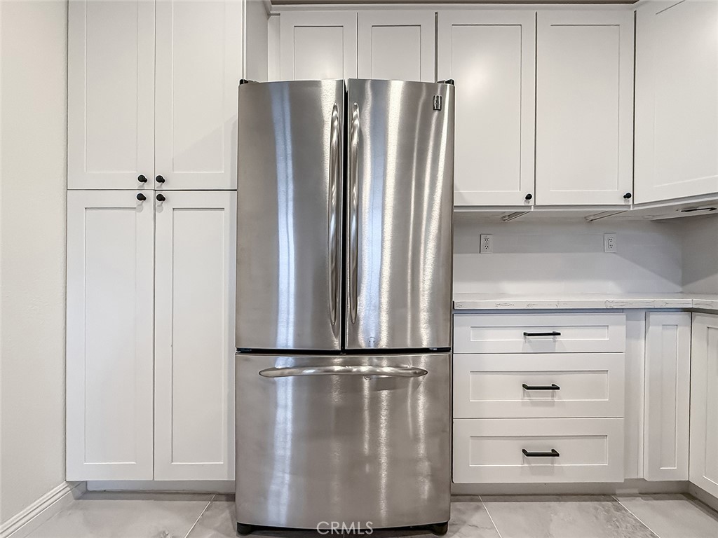 6834 Simmons Way Moorpark, CA 93021 - Photo 15 of 40 a view of a kitchen with refrigerator and cabinets