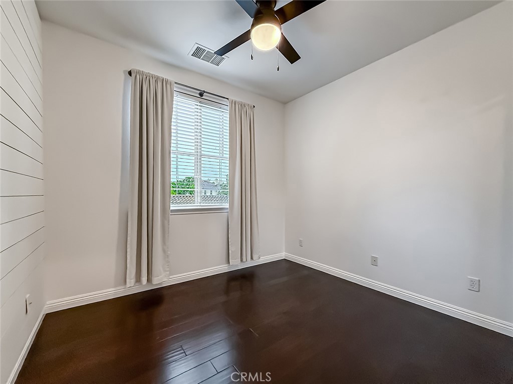 6834 Simmons Way Moorpark, CA 93021 - Photo 17 of 40 an empty room with wooden floor and windows