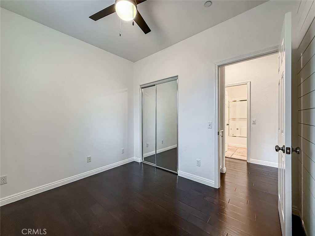 6834 Simmons Way Moorpark, CA 93021 - Photo 18 of 40 an empty room with wooden floor and ceiling fan