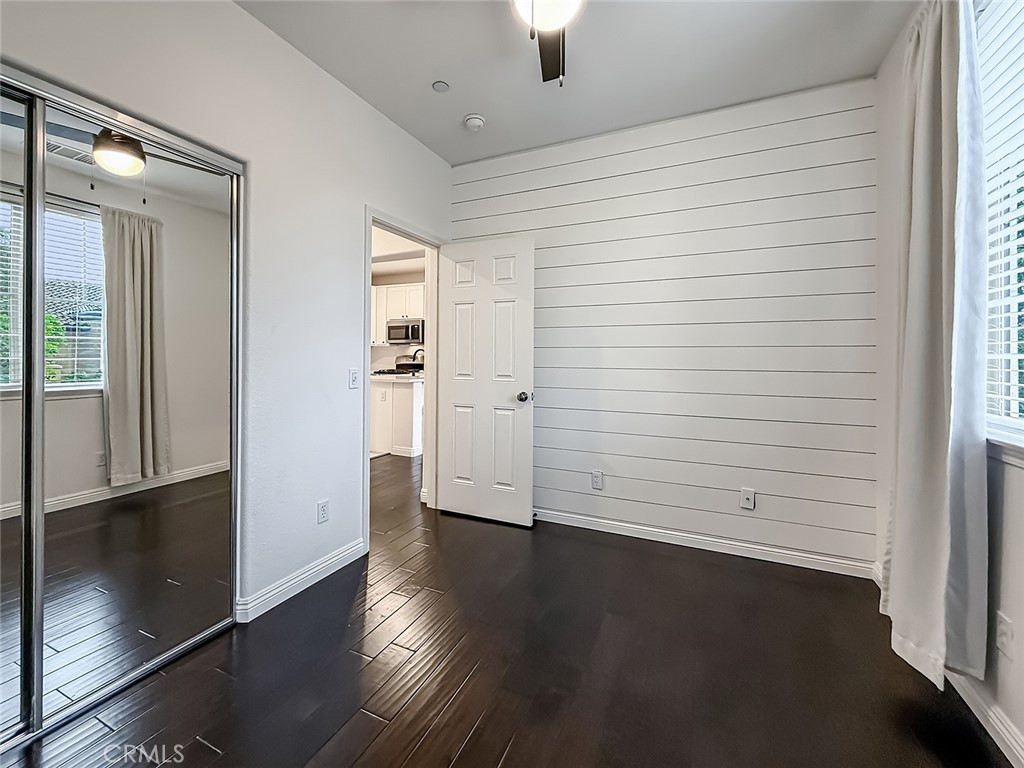 6834 Simmons Way Moorpark, CA 93021 - Photo 19 of 40 an empty room with wooden floor cabinet and windows