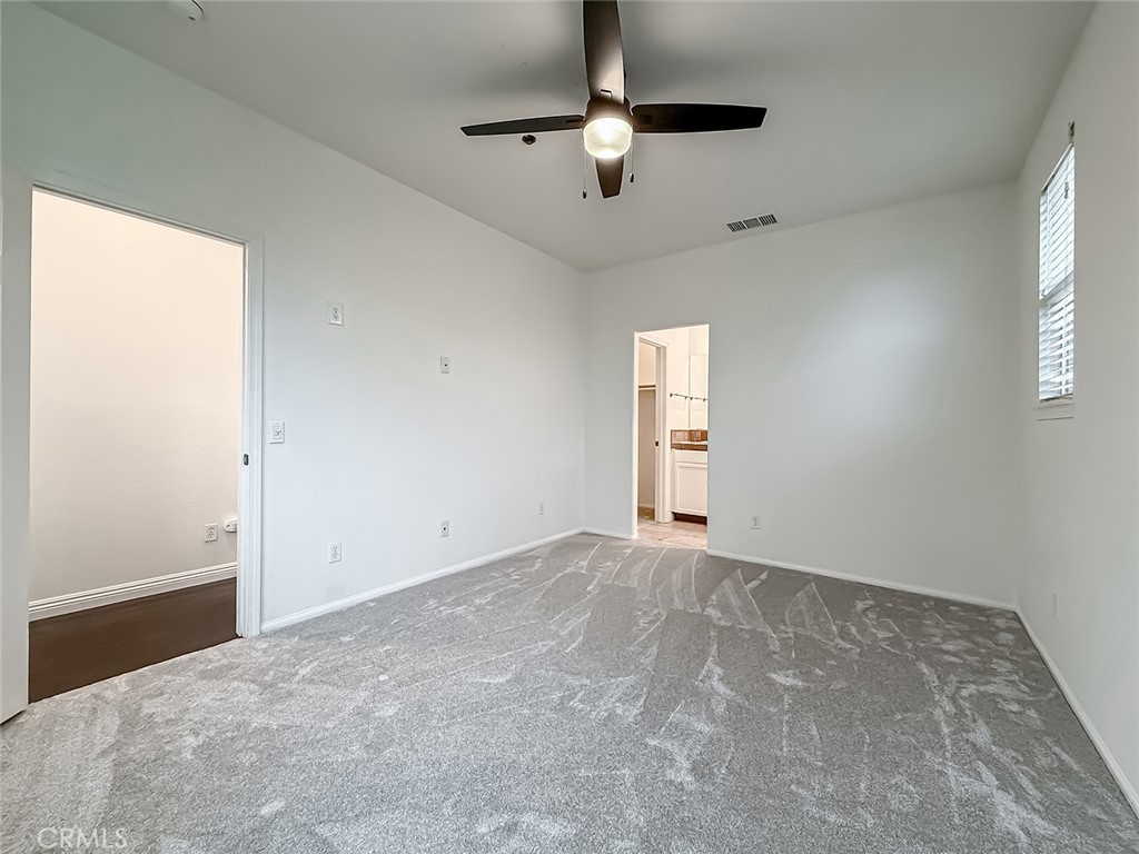 6834 Simmons Way Moorpark, CA 93021 - Photo 28 of 40 an empty room with windows and fan