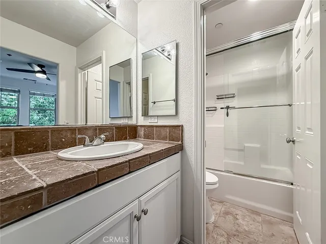 a bathroom with a granite countertop sink mirror and double