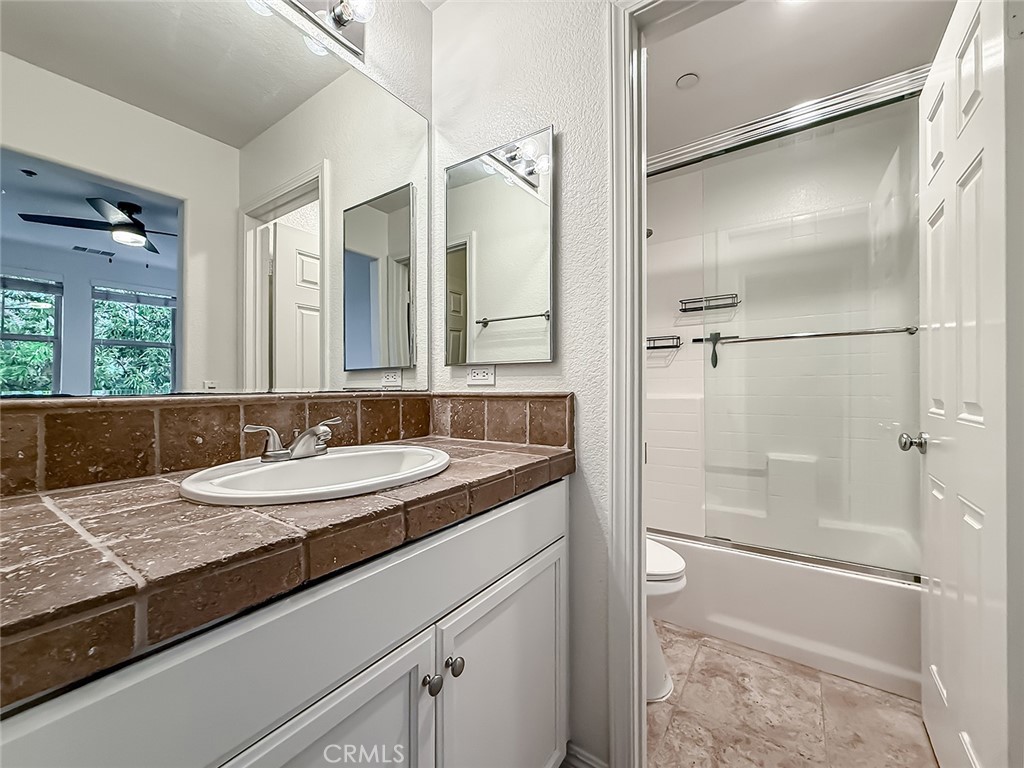 6834 Simmons Way Moorpark, CA 93021 - Photo 30 of 40 a bathroom with a granite countertop sink mirror and double