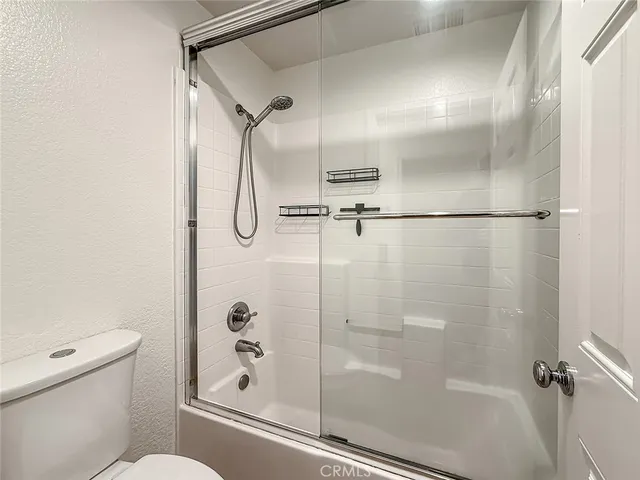 a bathroom with a glass shower door