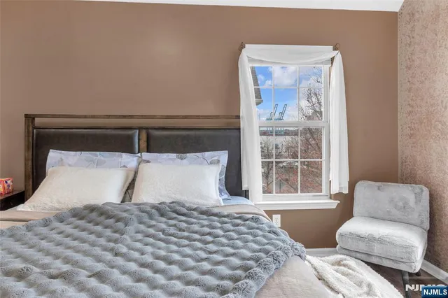 a bedroom with a large bed and a window