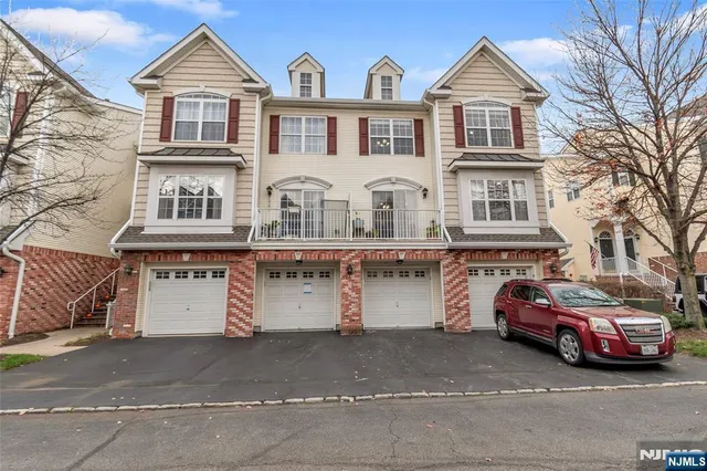 a front view of a house with parking space