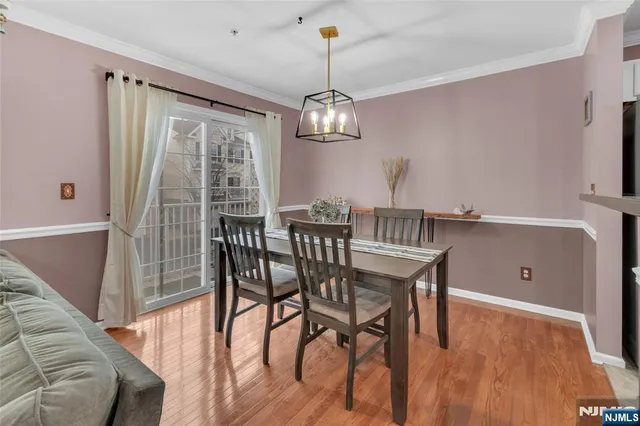 a view of a dining room with furniture wooden floor and chandelier