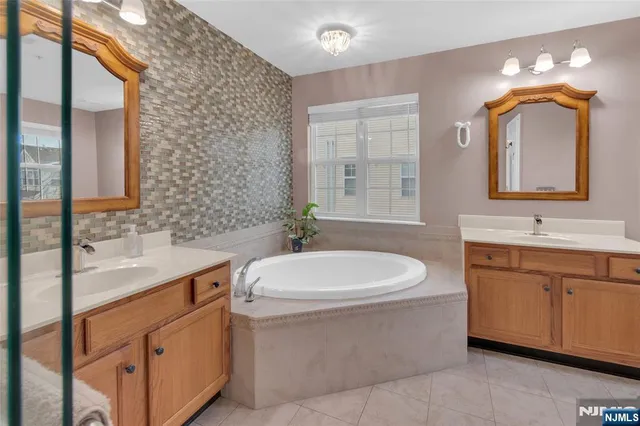 a bathroom with a toilet a sink a mirror a vanity and window