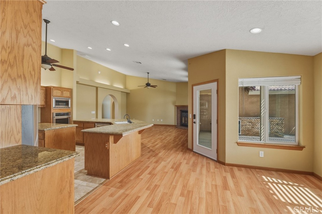 19501 Kinai Road Apple Valley, CA 92307 - Photo 22 of 49 a kitchen with stainless steel appliances granite countertop a stove and a refrigerator