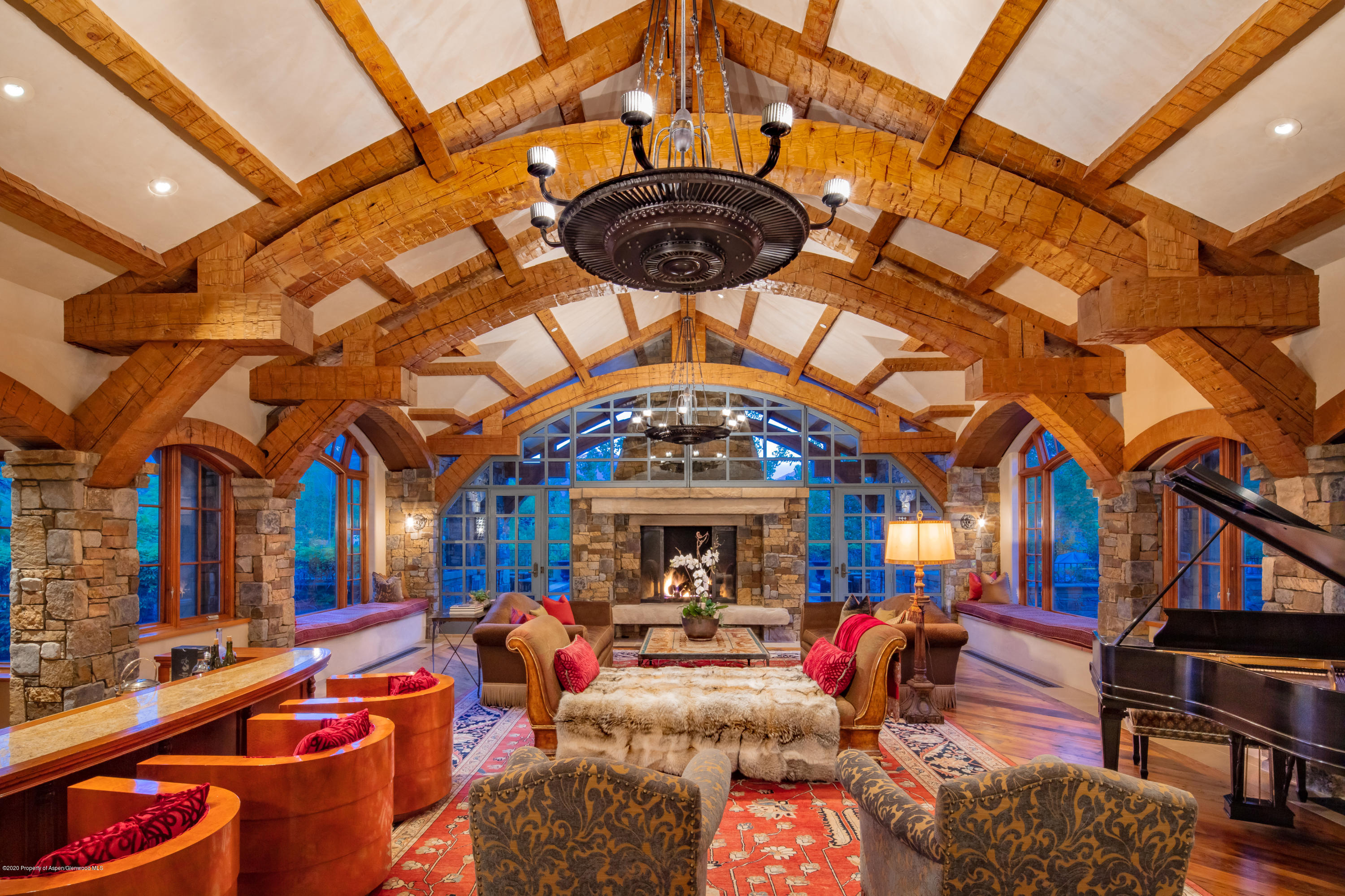 835 Red Mountain Road Aspen, CO 81612 - Photo 4 of 24 a living room with furniture a chandelier and a fireplace