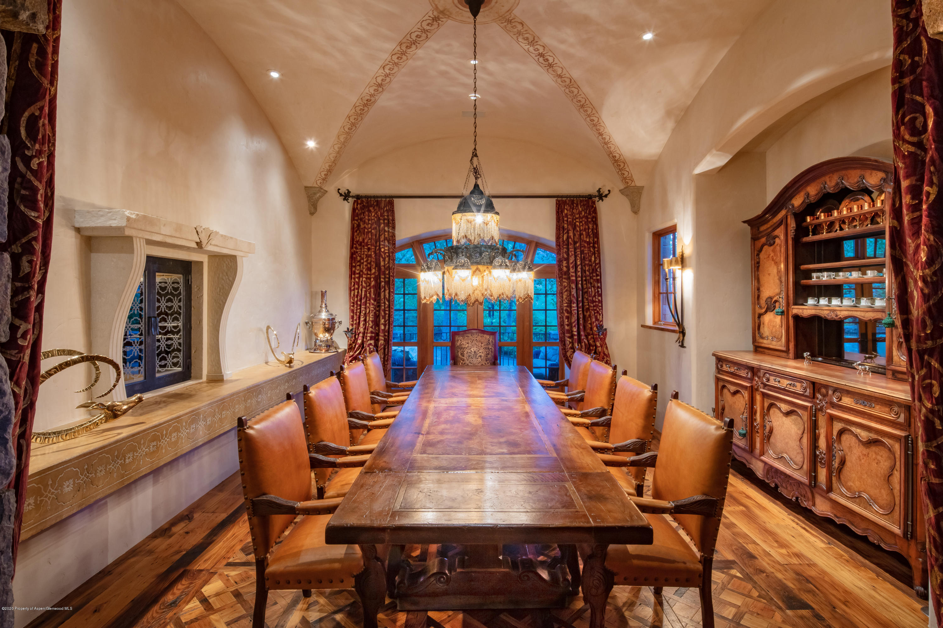 835 Red Mountain Road Aspen, CO 81612 - Photo 9 of 24 a dining room with wooden floor a chandelier a wooden table and chairs