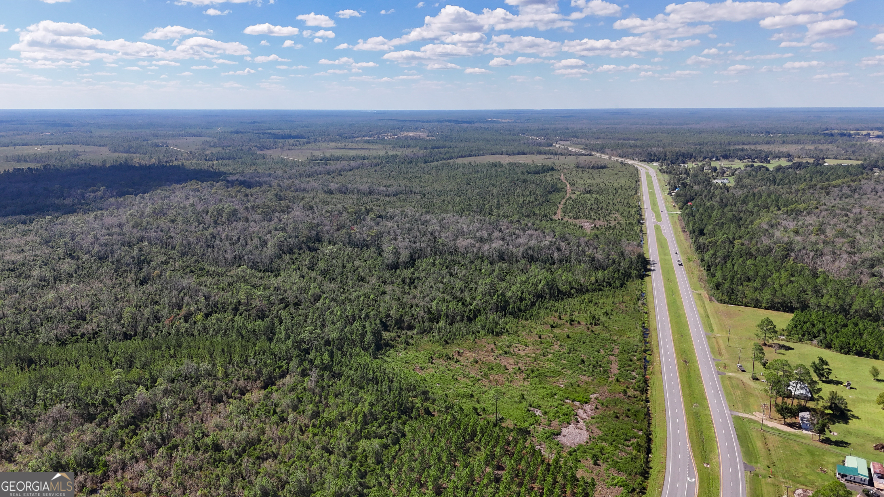 0 Highway 84, Unit 1 Homerville, GA 31634 - Photo 2 of 10 a view of a city with lush green forest