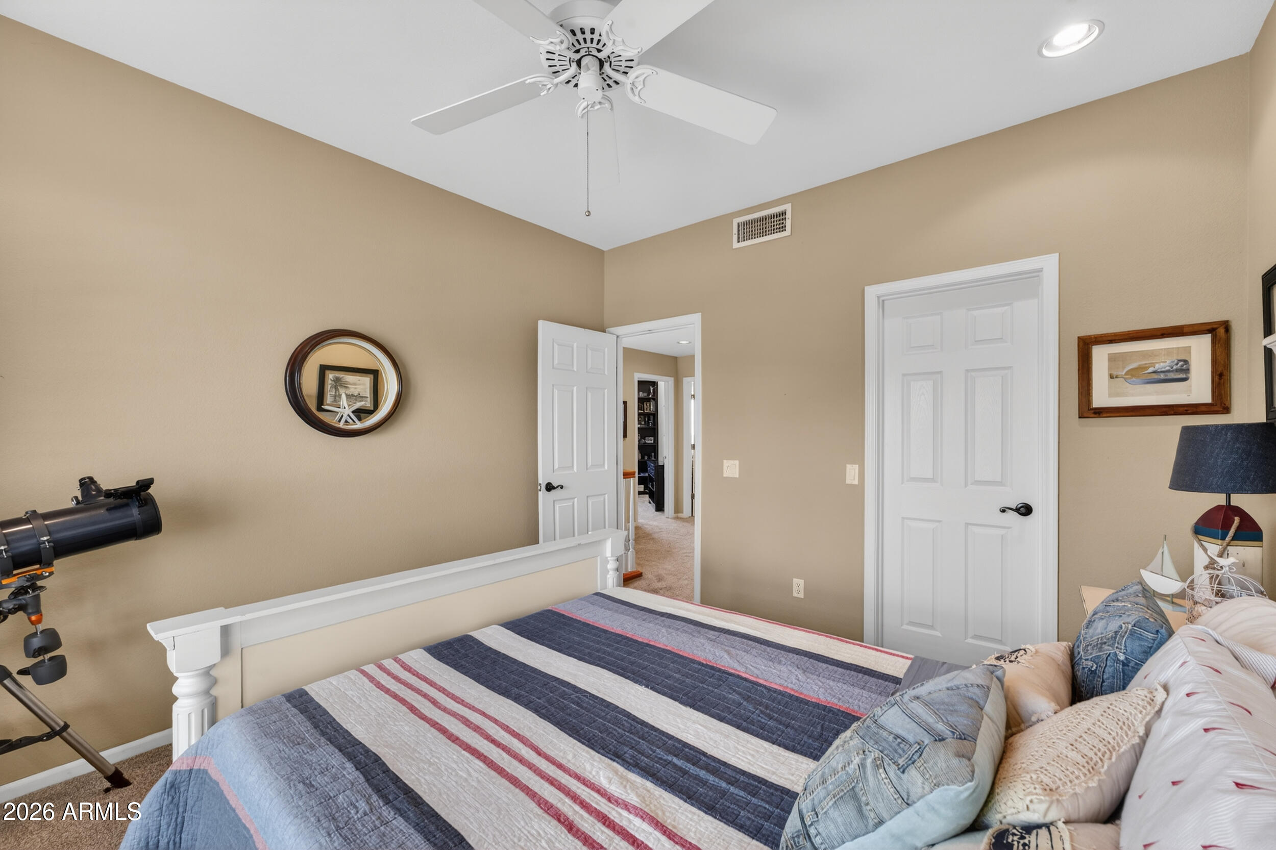 1539 East Winged Foot Road Phoenix, AZ 85022 - Photo 40 of 64 a bedroom with a bed and a chandelier